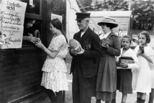 1923, Germany --- People exchange bread, sausage, jam and other goods for circus tickets. A food emergency in Germany after the First World War and the catastrophic collapse of German currency led to the fact that material assets were used in place of money. --- Image by © Keystone/Corbis